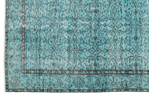 Load image 1 in gallery view. Turquoise and black distressed rug with a traditional floral medallion pattern and a geometric border.