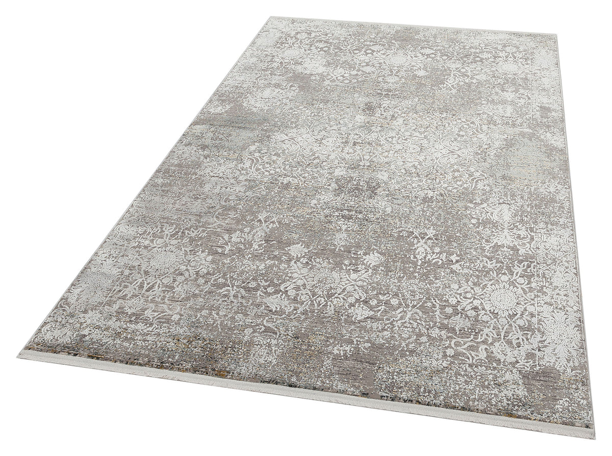 Grey and white area rug with a distressed, traditional floral medallion pattern on a white background.
