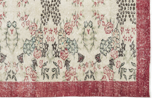 Load image 1 in gallery view. Distressed cream rug with a floral pattern in red, green, and black, featuring a wide red border.