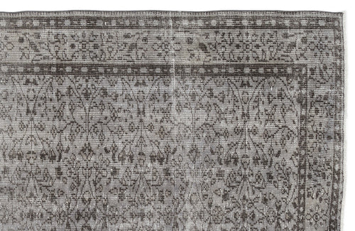 Load image 1 in gallery view. Grey and charcoal distressed rug with a traditional floral vine pattern and a geometric border.