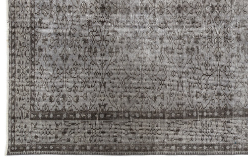 Load image 1 in gallery view. Grey and charcoal distressed rug with a traditional floral medallion pattern and a geometric border.