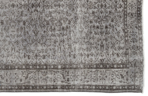 Load image 1 in gallery view. Grey and charcoal distressed rug with a traditional floral medallion pattern and a geometric border.