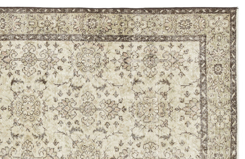 Load image 1 in gallery view. A close-up of the Lagata - Vintage Floral Rug (6'2 x 9'9) displays beige and brown floral and vine motifs with a wide, darker border framing the lighter center, emphasizing the vintage rug’s intricate craftsmanship.