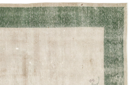 Load image 1 in gallery view. Beige rug with a distressed forest green border and a flat-weave texture.