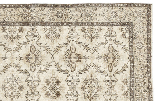 Load image 1 in gallery view. Beige and brown vintage-style rug with a distressed floral medallion pattern and a decorative border.