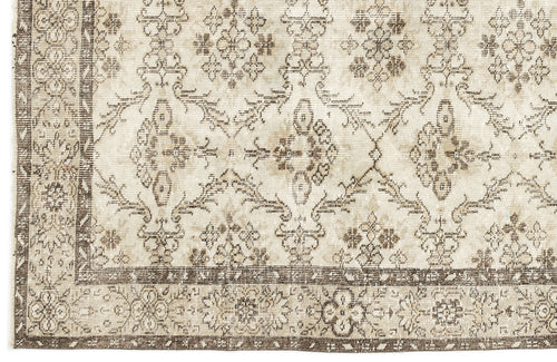 Load image 1 in gallery view. Beige and brown rug with a distressed traditional floral medallion pattern and a wide decorative border.