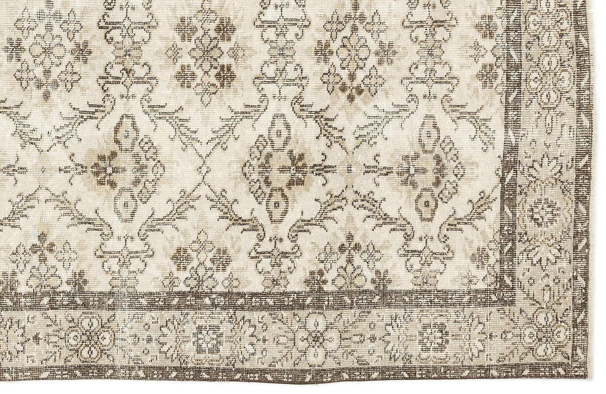 Beige and brown distressed rug with a traditional floral medallion pattern and a wide decorative border.