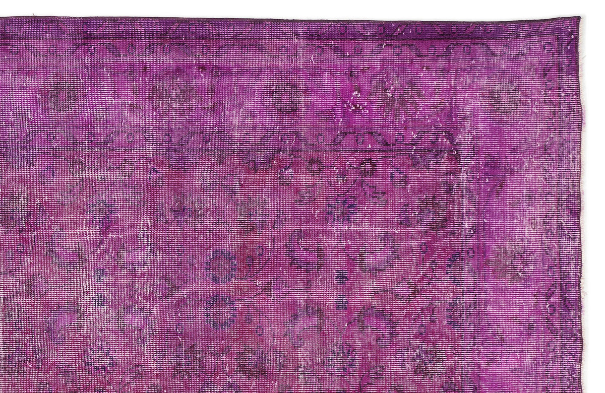 Magenta vintage-style rug with a distressed, faded traditional floral medallion pattern on a white background.