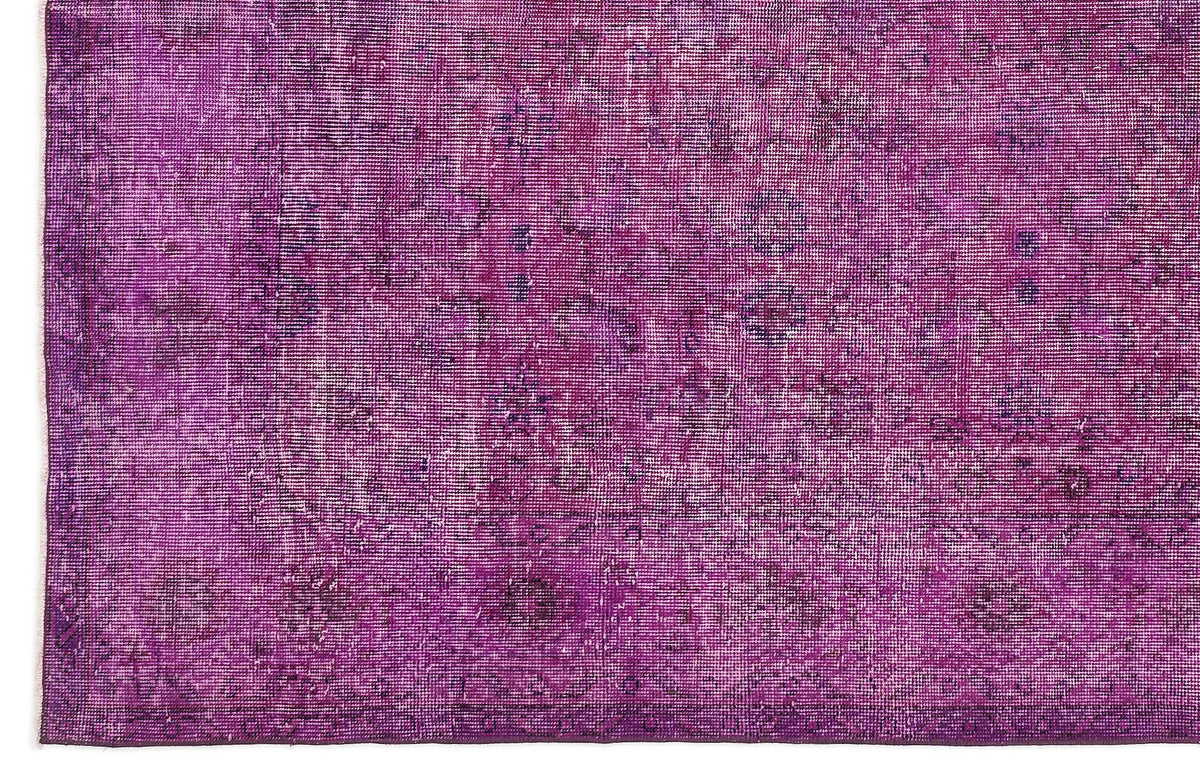 Deep purple vintage-style rug with a distressed, faded traditional medallion pattern.