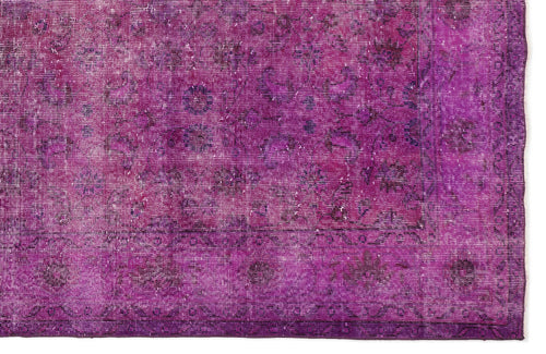 Load image 1 in gallery view. Magenta distressed vintage-style rug with a faded traditional floral medallion pattern.