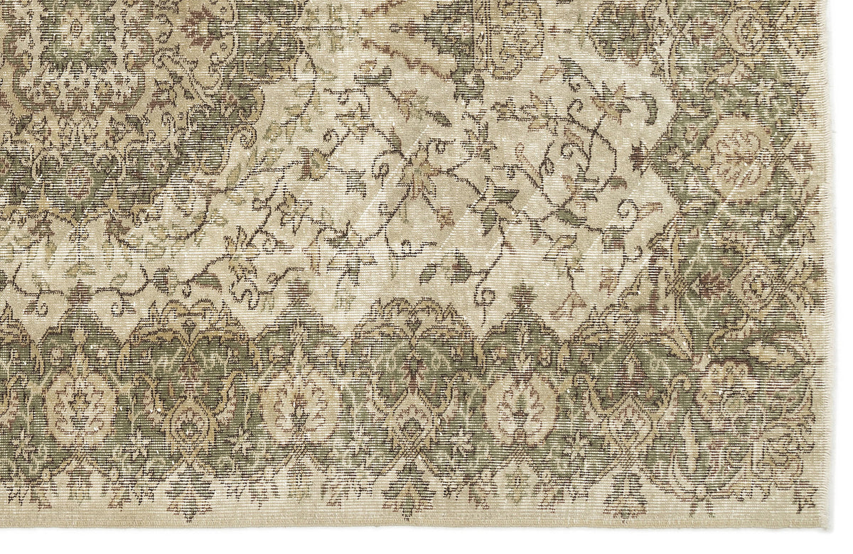 A close-up of the Seudian Vintage Medallion Rug (5'9 x 8'9) shows ornate floral and geometric patterns in muted beige, green, and brown. Intricate details and faded areas lend this rug an authentic antique look.