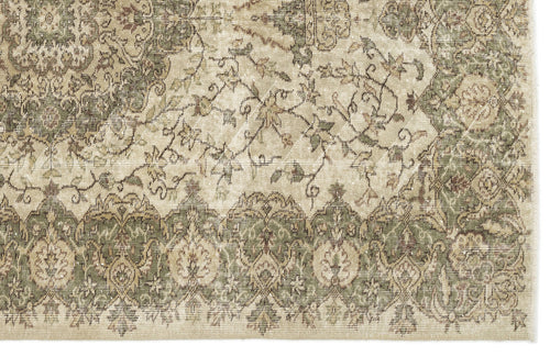 Load image 1 in gallery view. A close-up of the Seudian Vintage Medallion Rug (5'9 x 8'9) shows ornate floral and geometric patterns in muted beige, green, and brown. Intricate details and faded areas lend this rug an authentic antique look.