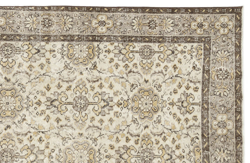 Load image 1 in gallery view. Beige and brown traditional rug with a distressed floral medallion pattern and a detailed geometric border.