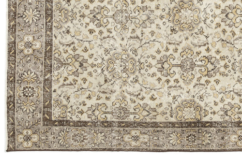 Load image 1 in gallery view. Distressed beige, grey, and brown rug with a traditional floral medallion pattern and a wide decorative border.
