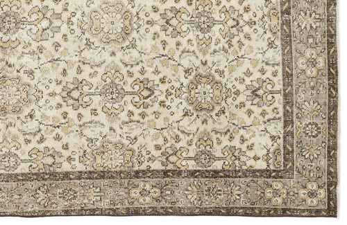 Load image 1 in gallery view. Cream, beige, and dark brown rug with a traditional distressed floral medallion pattern and a wide decorative border.