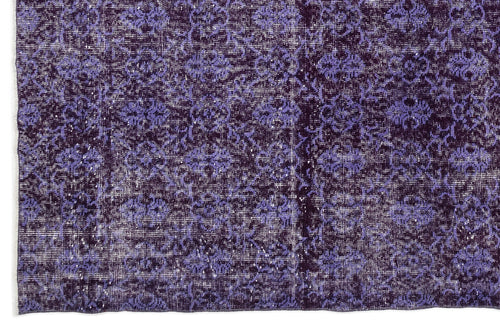 Load image 1 in gallery view. Deep purple and lavender distressed rug with a repeating floral medallion pattern.