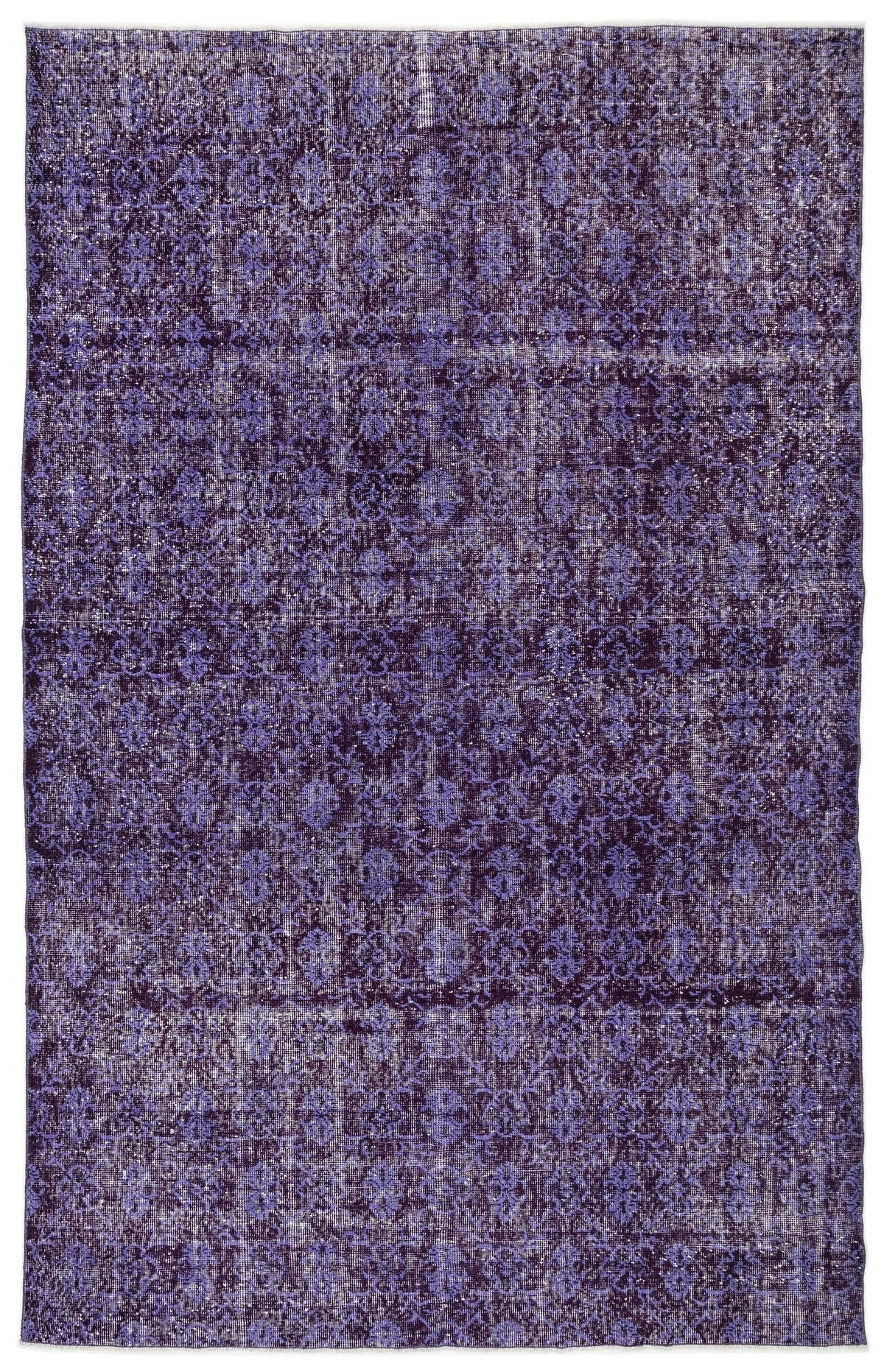 Deep purple distressed rug with a repeating traditional medallion pattern and a faded, worn texture.
