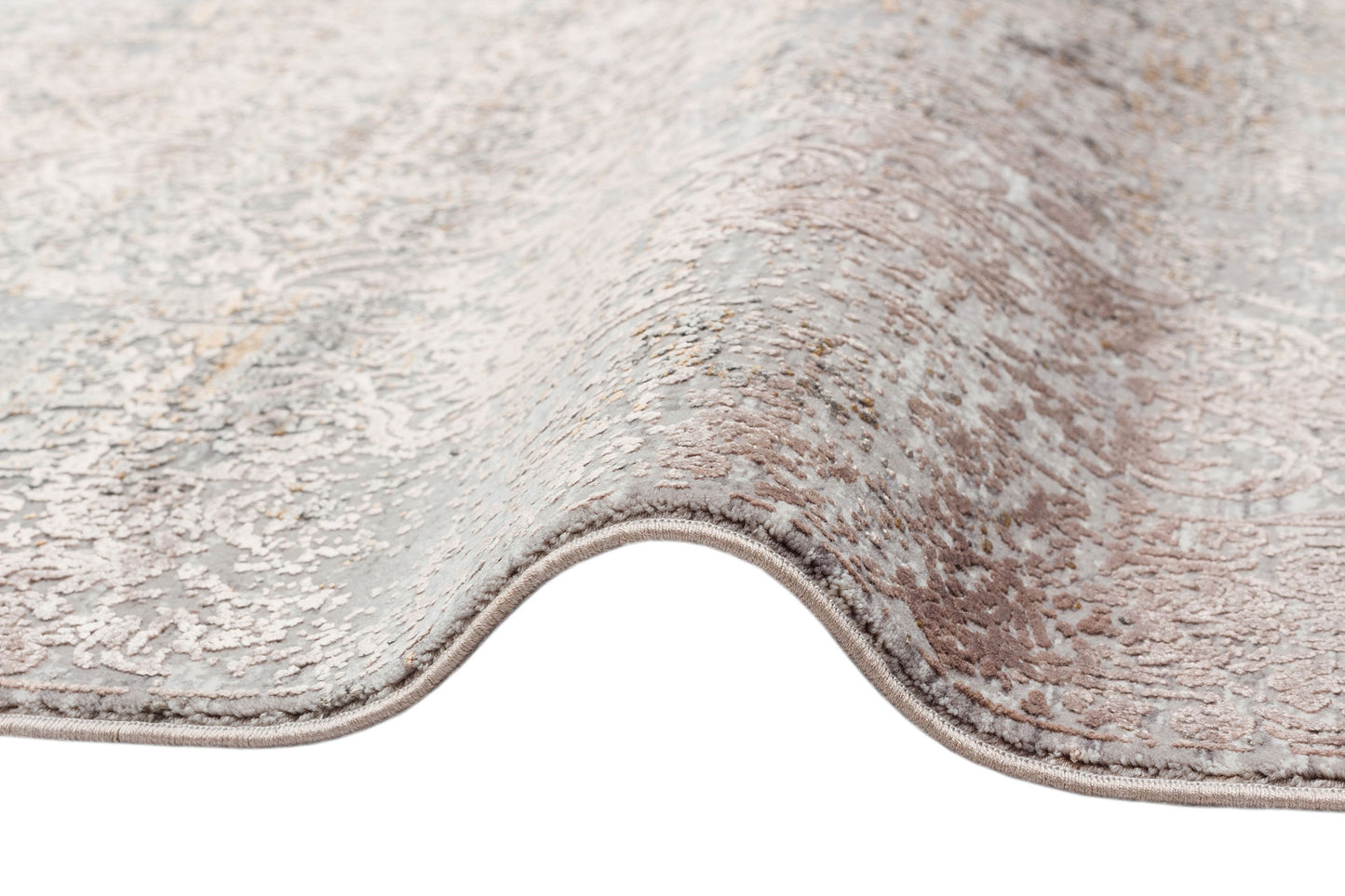 Grey and taupe rug with a distressed, faded traditional medallion pattern and a finished serged edge.