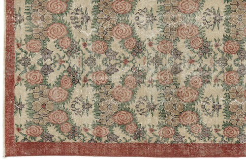 Load image 1 in gallery view. Beige rug with a distressed floral pattern in muted red and green, featuring a solid red border.