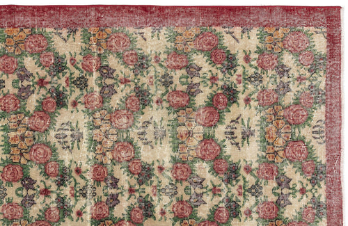 Load image 1 in gallery view. Beige rug with a red border and a repeating floral pattern in red, yellow, and green on a white background.