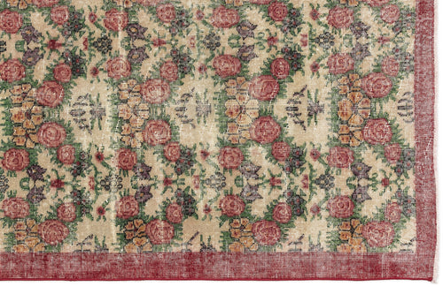 Load image 1 in gallery view. Beige rug with a distressed floral pattern in red, green, and yellow, featuring a solid red border.