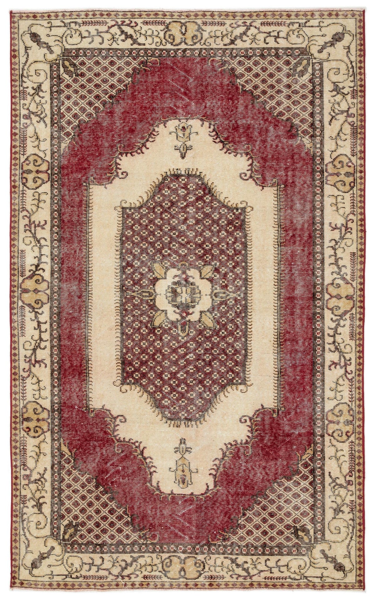 Red and cream vintage-style rug with a central medallion, geometric lattice field, and ornate floral border.