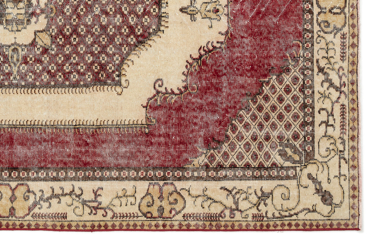 Distressed cream and deep red traditional rug with a geometric lattice pattern and ornate floral border.