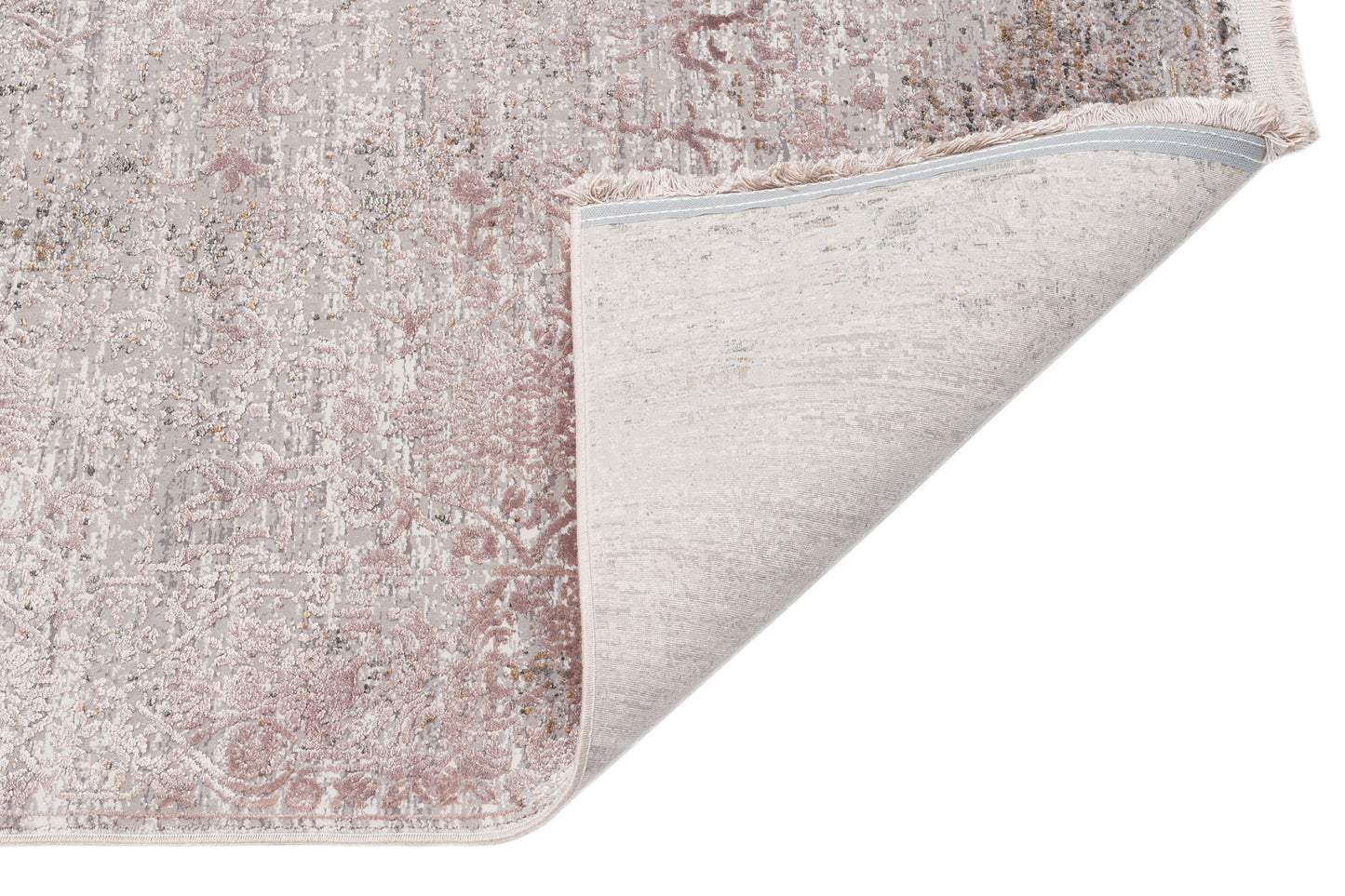 Distressed blush pink and grey traditional medallion rug with a folded corner showing the woven backing and fringe.