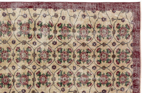 Load image 1 in gallery view. Beige rug with a dark red border and a repeating floral medallion pattern in red, green, and brown on a grid.