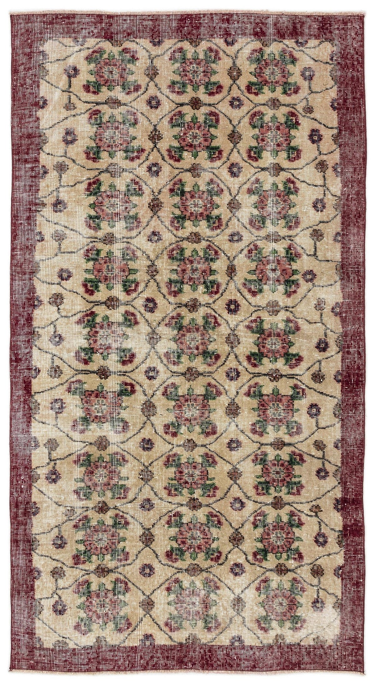 Beige rug with a red border and a repeating floral medallion pattern in red and green, featuring a distressed finish.