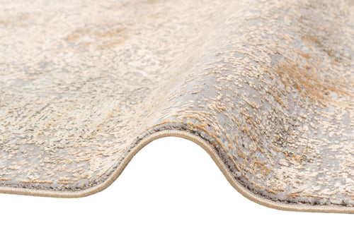 Load image 1 in gallery view. Grey and gold rug with a distressed, faded traditional pattern, shown folded on a white background.