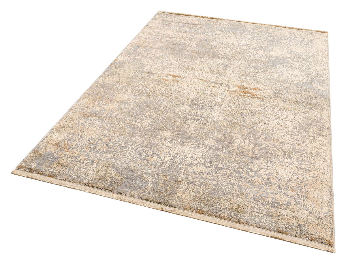 Beige and grey distressed area rug with a faded traditional floral medallion pattern and fringed edges.