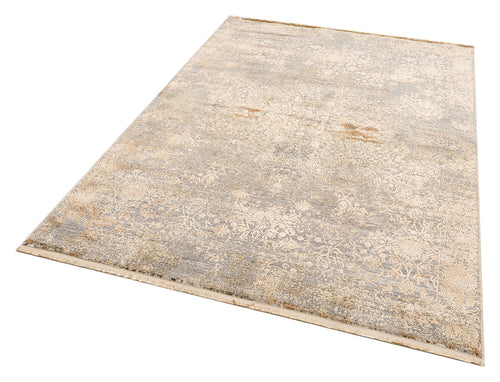 Load image 1 in gallery view. Beige and grey distressed area rug with a faded traditional floral medallion pattern and fringed edges.
