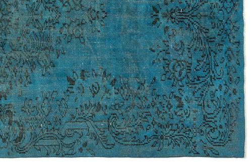 Load image 1 in gallery view. Teal rug with a distressed black floral medallion pattern and a fringed edge.