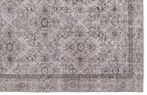 Load image 1 in gallery view. Grey and charcoal distressed rug with a traditional floral medallion pattern and a bordered edge.