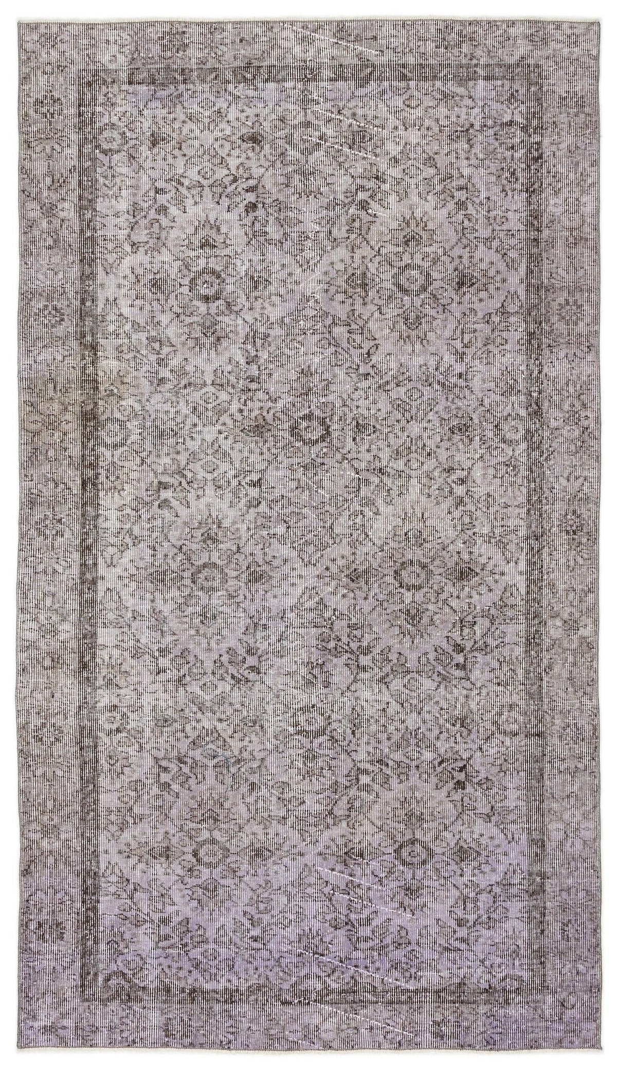 Grey and charcoal distressed traditional rug with a faded floral medallion pattern and a bordered edge.