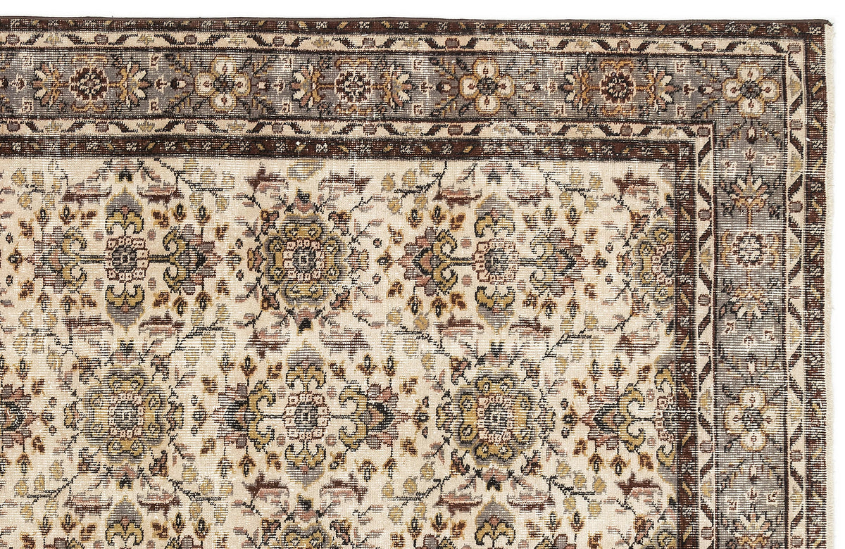 Cream rug with a traditional floral medallion pattern in brown, grey, and muted gold, featuring a detailed border.