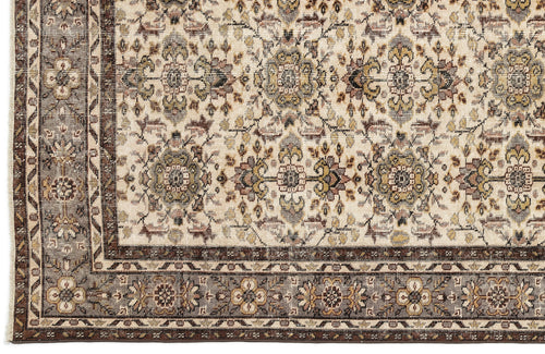 Load image 1 in gallery view. Cream rug with a traditional floral medallion pattern in brown, olive, and grey, featuring a detailed geometric border.