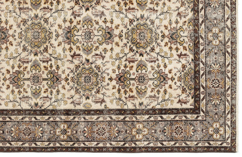 Load image 1 in gallery view. Cream rug with a traditional floral medallion pattern in brown, grey, and gold, featuring a detailed geometric border.