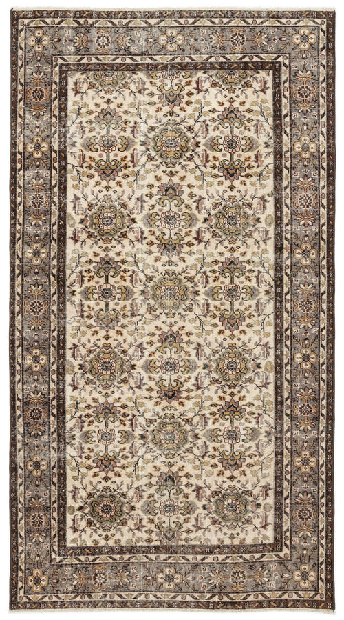 Load image 1 in gallery view. Cream and brown traditional rug with a repeating floral medallion pattern and a dark decorative border.