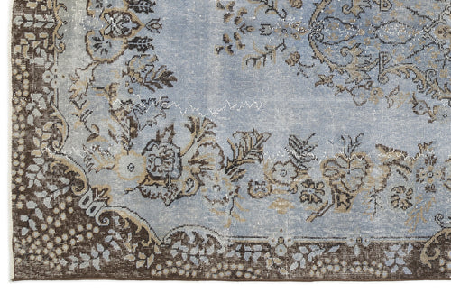 Load image 1 in gallery view. Light blue and brown distressed rug with a traditional floral medallion pattern and ornate border.