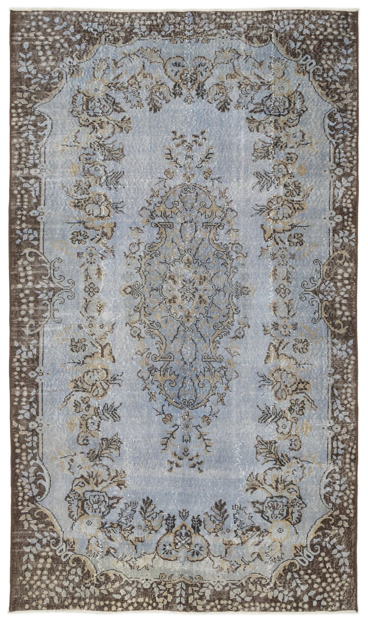 Light blue and brown distressed rug with a central floral medallion and ornate border pattern.