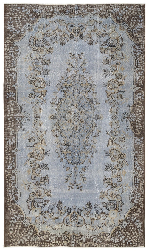Load image 1 in gallery view. Light blue and brown distressed rug with a central floral medallion and ornate border pattern.