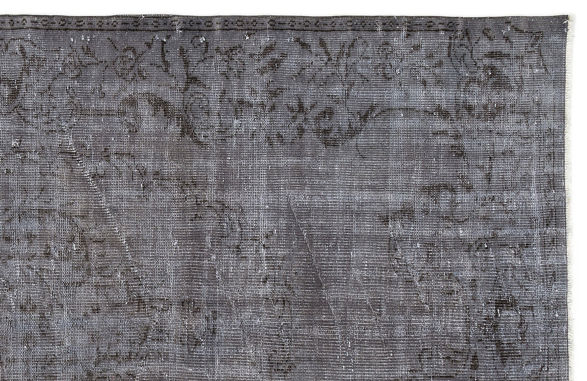 Charcoal grey vintage-style rug with a faded, distressed floral medallion pattern and a detailed border.