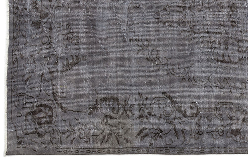 Load image 1 in gallery view. Charcoal grey distressed rug with a faded traditional floral medallion pattern and a visible woven texture.
