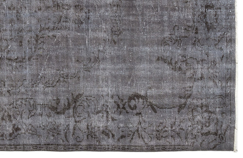 Load image 1 in gallery view. Charcoal grey rug with a faded, distressed traditional medallion pattern and a visible fringe edge.
