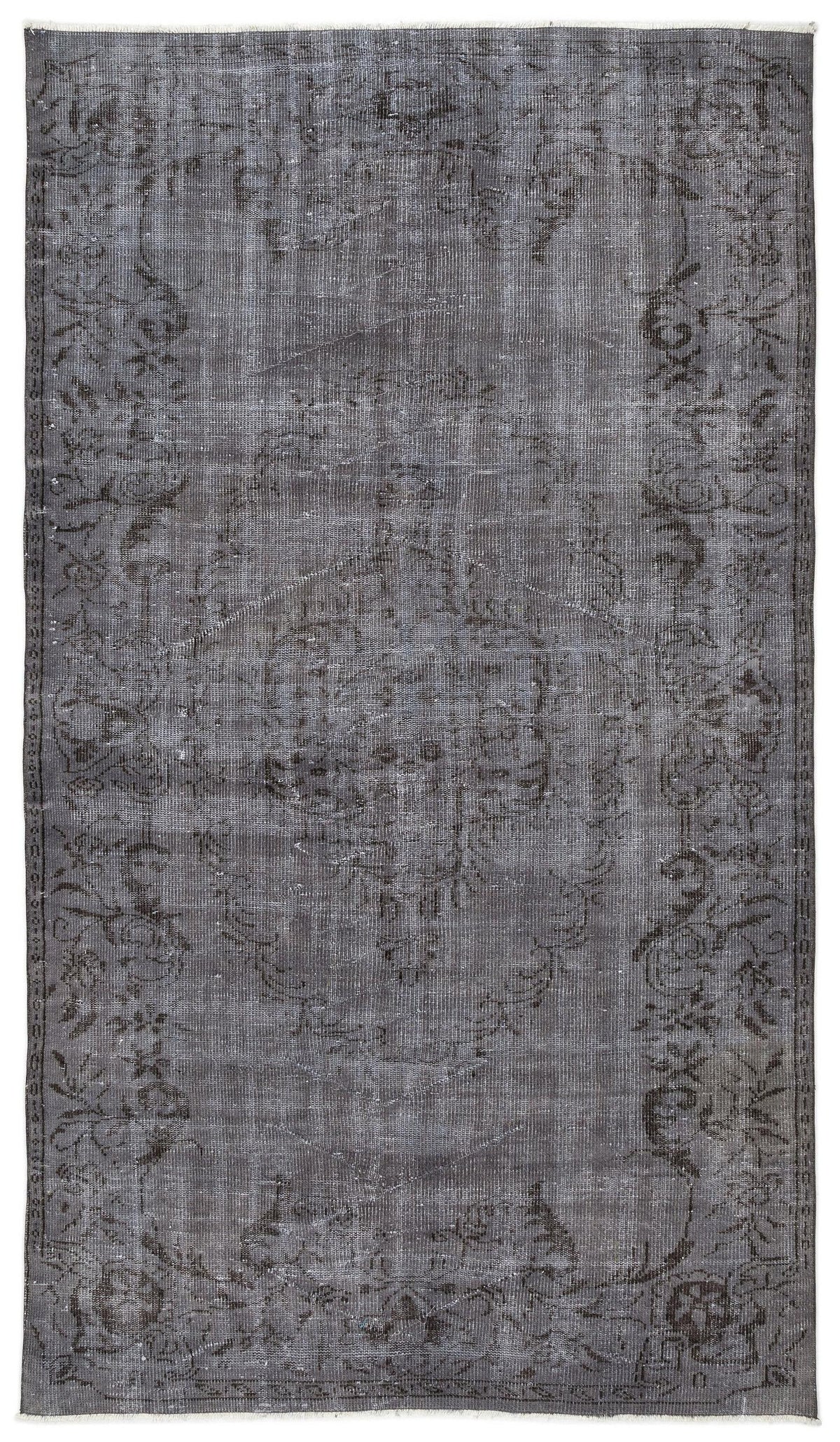 Charcoal grey vintage-style rug with a faded floral medallion pattern and a decorative border on a white background.