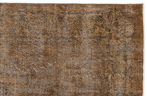 Load image 1 in gallery view. Distressed brown rug with a faded traditional floral medallion pattern on a white background.