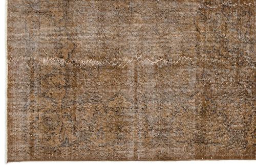 Load image 1 in gallery view. Brown and white distressed rug with a faded traditional medallion pattern.