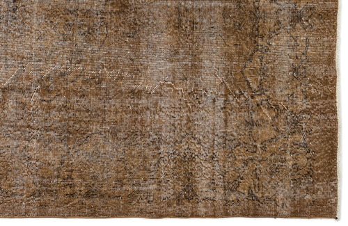 Load image 1 in gallery view. Brown distressed rug with a faded traditional medallion pattern and white fringe edge.